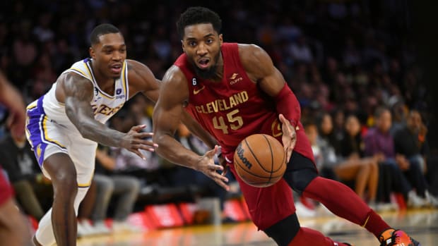 Cleveland Cavaliers guard Donovan Mitchell (45) drives past Los Angeles Lakers guard Lonnie Walker IV (4) for a basket in the first half at Crypto.com Arena.